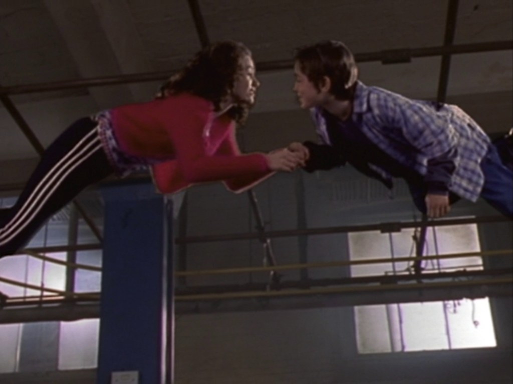 Charlie and Claire floating, about to kiss